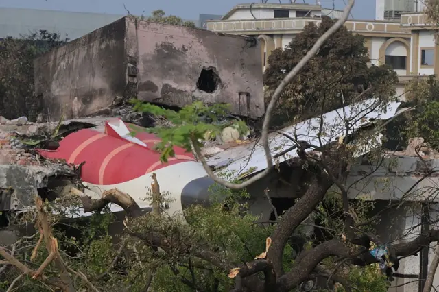 Los restos que muestran la sección de cola del Boeing 787-8 de Air India se muestran en una zona residencial cerca del aeropuerto de Ahmedabad.