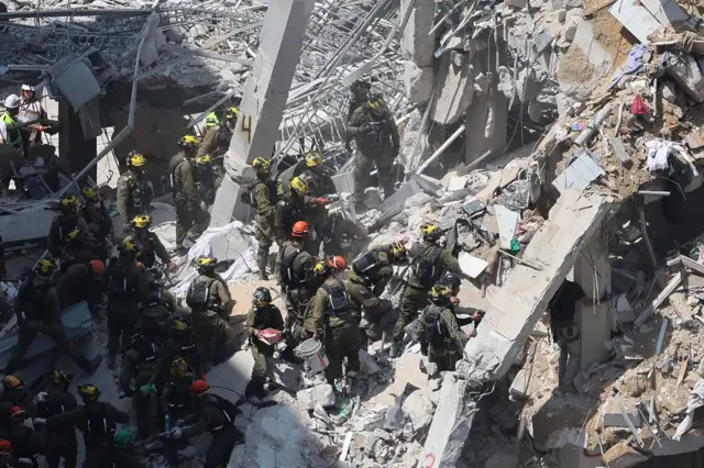 Un grupo de rescatistas entre los escombros de un edificio