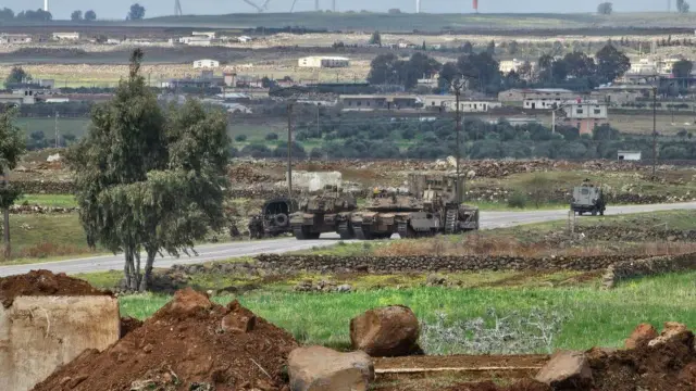 Foto de archivo que muestra tanques israelíes y una excavadora militar atravesando el puesto militar de Abu Diab, en la periferia sur de la ciudad siria de Quneitra (19 de marzo de 2025).