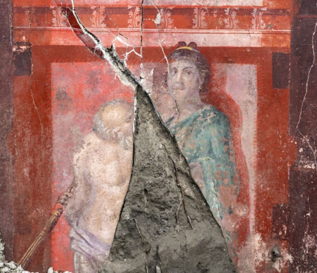 Figura femenina y figura anciana en un fresco de Pompeya