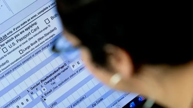 Una persona comienza el proceso de llenar una solicitud de pasaporte con un marcador de género X, en su hogar en Alexandria, Virginia, el 11 de abril de 2022. Foto de STEFANI REYNOLDS/AFP a través de Getty Images.