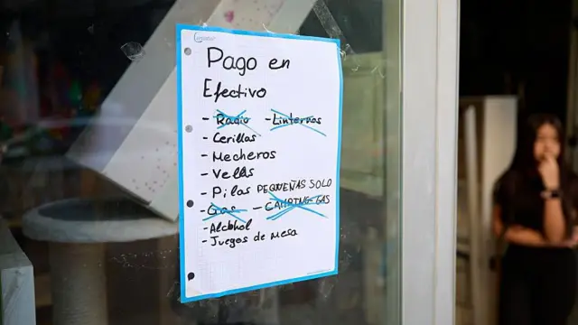 Un cartel en una tienda muestra la lista de cosas y pide pago solo en efectivo.