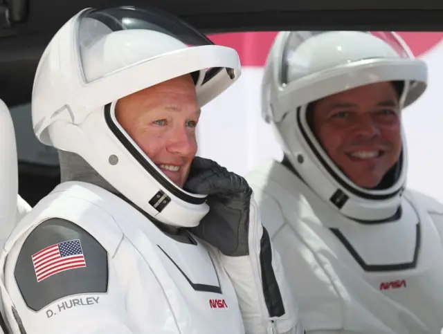 Dos astronautas de SpaceX usando sus trajes espaciales.