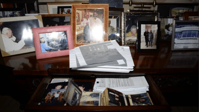 An image of lots of framed photos on the desk is released as part of the latest batch of the Epstein files