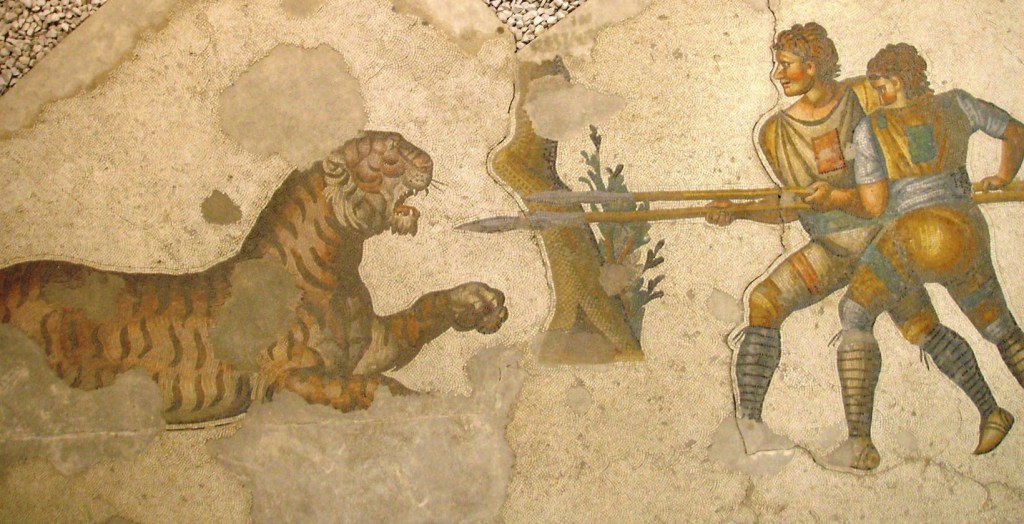 Lucha con animales en mosaico romano