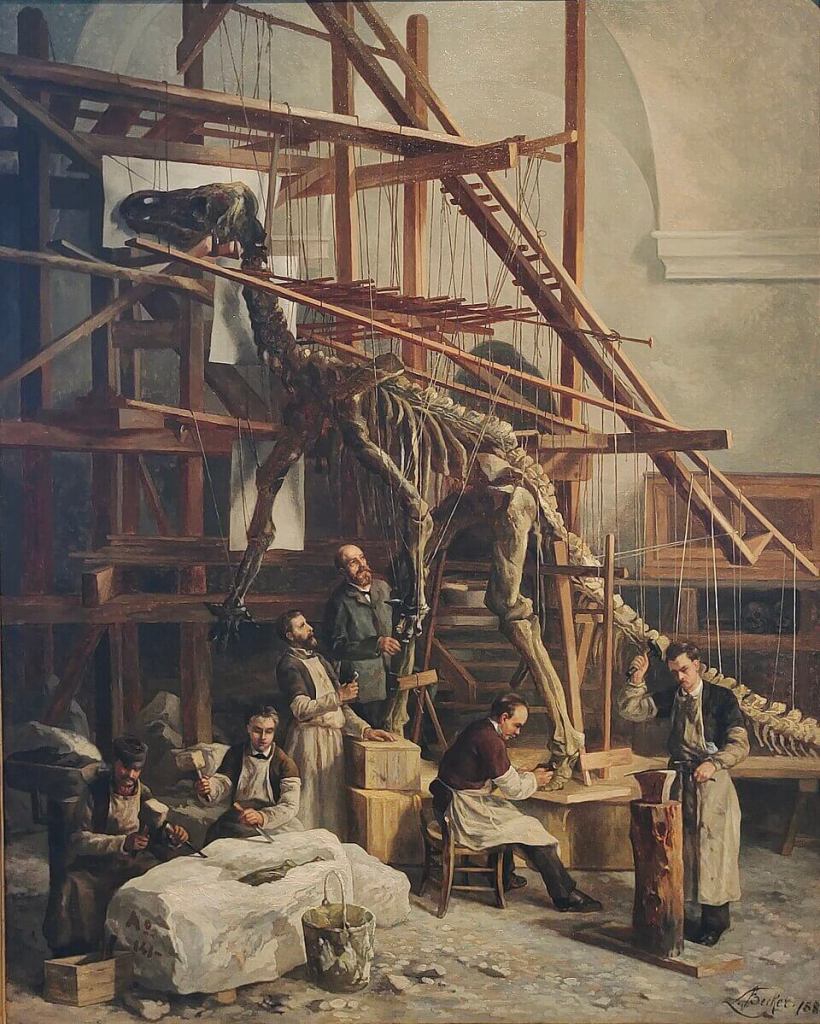 Ilustración sobre el primer montaje de un esqueleto del ornitópodo Iguanodon en la capilla de San Jorge (Bruselas, Bélgica) en 1882. Dicho montaje fue dirigido científicamente por el paleontólogo Louis Dollo. Pintura de L. Becker expuesta en el Instituto Real de Ciencias Naturales de Bélgica en Bruselas (Bélgica).