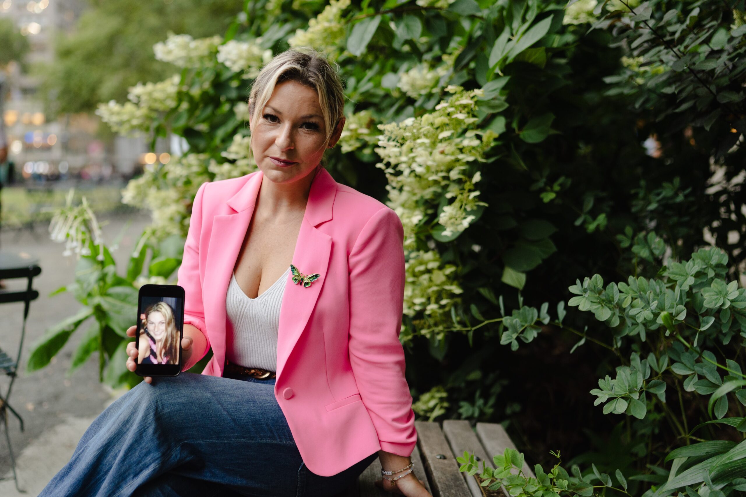 Dani Bensky, an Epstein survivor, holds a photo of herself as a teenager in Midtown Manhattan, New York.