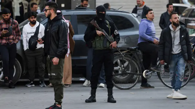 Un miembro de seguridad leal al nuevo gobierno sirio sostiene un arma durante una protesta contra la muerte de civiles y miembros de las fuerzas de seguridad vinculados a los nuevos gobernantes sirios.