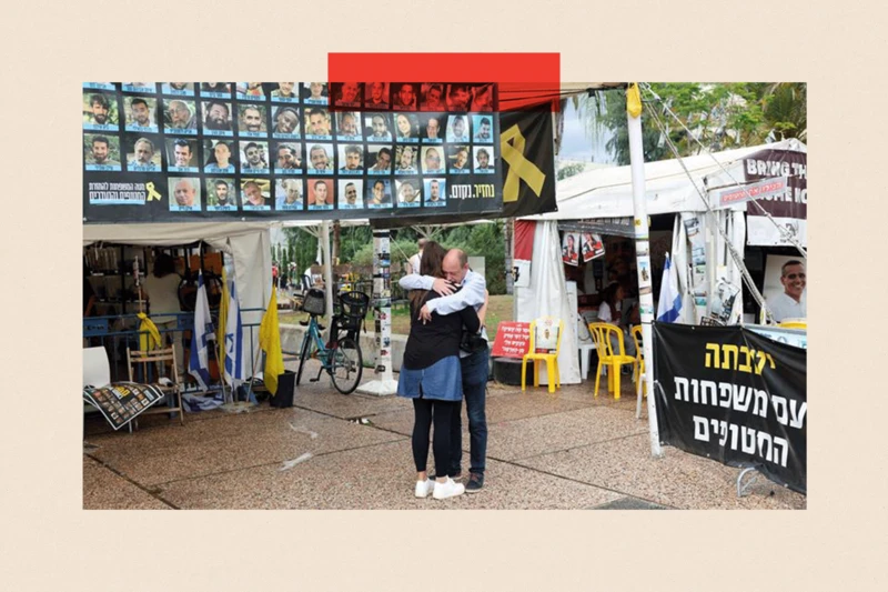 Una pareja se abraza frente a los afiches de los secuestrados.
