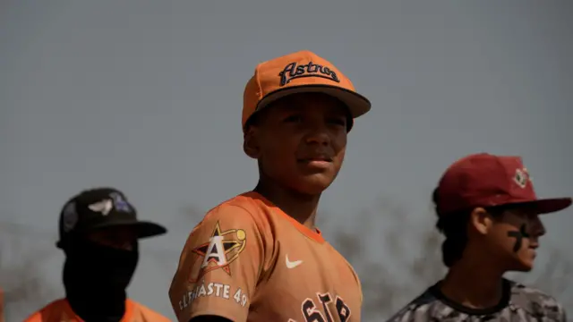 Niños jugando al béisbol.