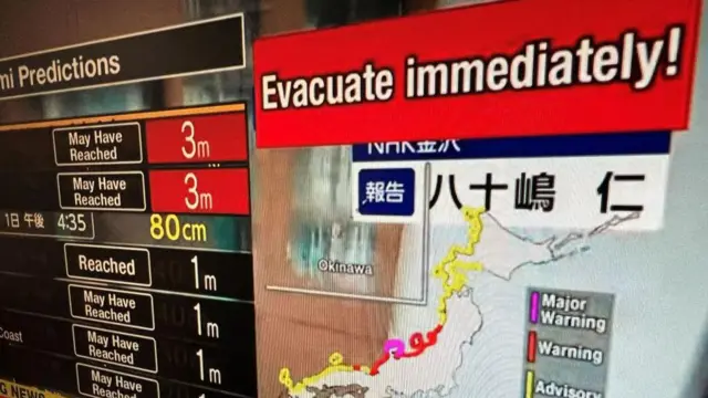 Un mensaje de advertencia en un programa de televisión pidiendo que evacuen el área después de una serie de grandes terremotos que azotaron el centro de Japón en enero de 2024.