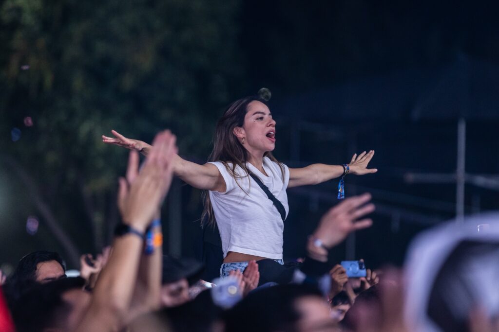 Chica con los brazos extendidos durante uno de los shows del Corona Capital.