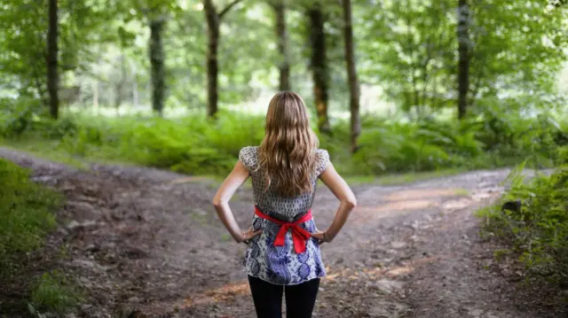 Mujer frente a dos caminos posibles