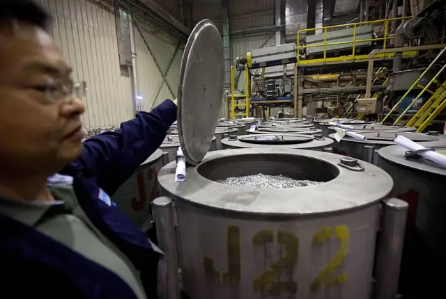 Un funcionario abre un contenedor con neodimio en la fábrica Neo Material Technologies Inc.'s Magnequench, en Tianjin, China