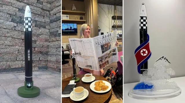 Una imagen dividida en tres fotos, la de la ziquierda es de un cohete grande de color negro que está sobre el suelo. La foto del centro es de Anastasia leyendo un periódico norcoreano, con una réplica del cohete sobre la mesa, en la que hay dos cafés y unos panes en un plato y en la tercera foto hay un cohete pequeño con la bandera de Corea del Norte sobre una meda